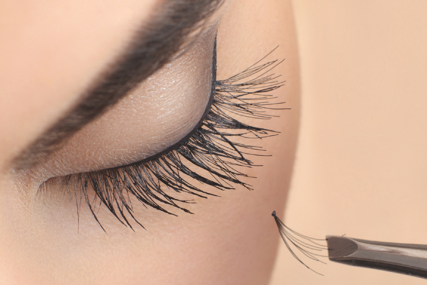 Close-up of eyelash extension being applied with focus on curing speed