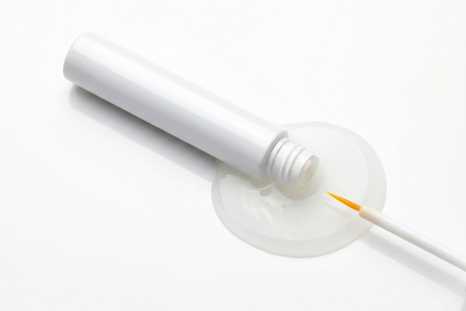 Black eyelash glue drop from bottle - showcasing OEM/ODM adhesive's pure black pigment and optional transparency for customized lash effects.