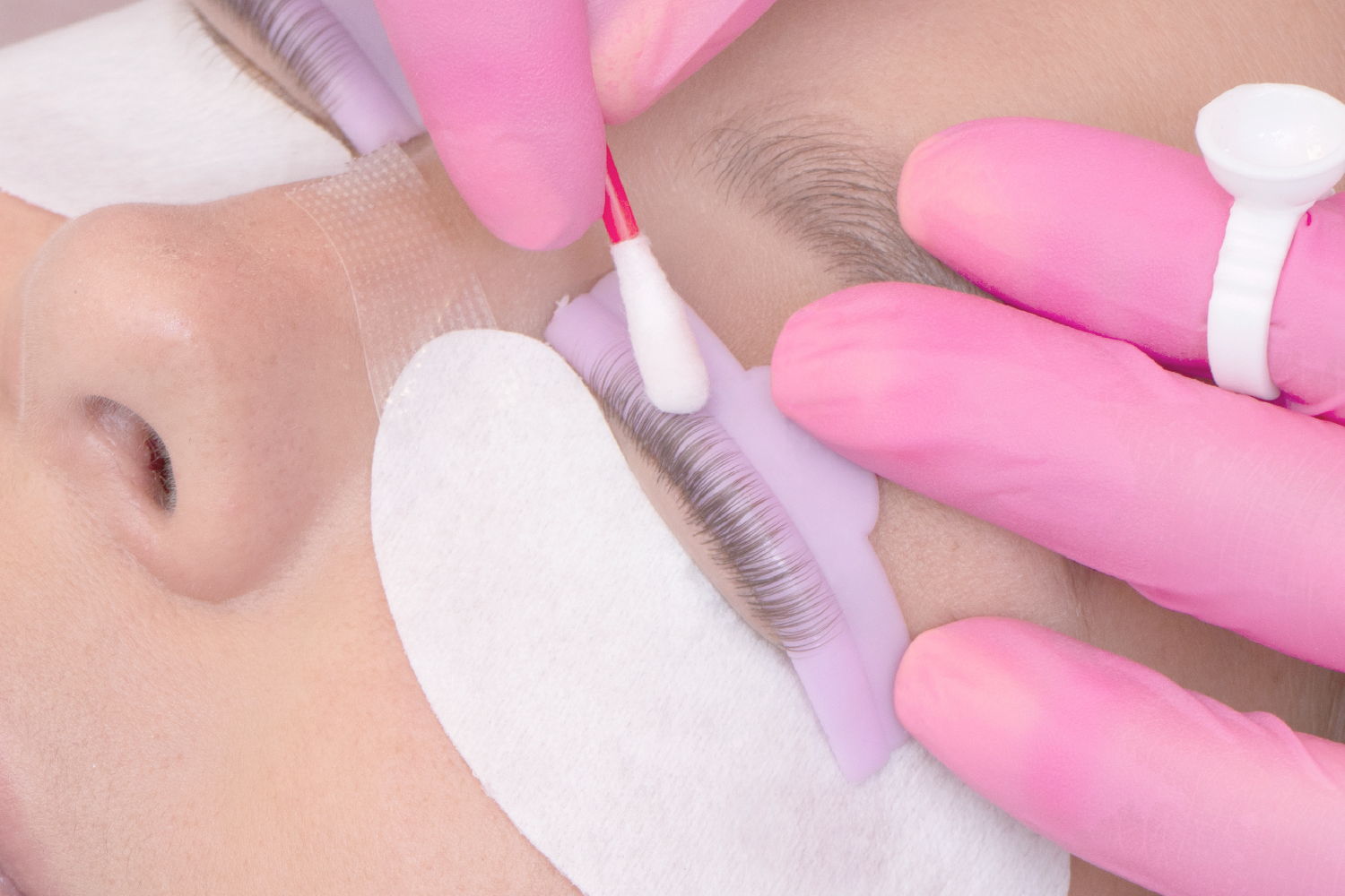 Eyelash nourishing treatment applied with a cotton swab after keratin lash lift, enhancing lash health and strength.